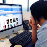 woman looking at Facebook in office